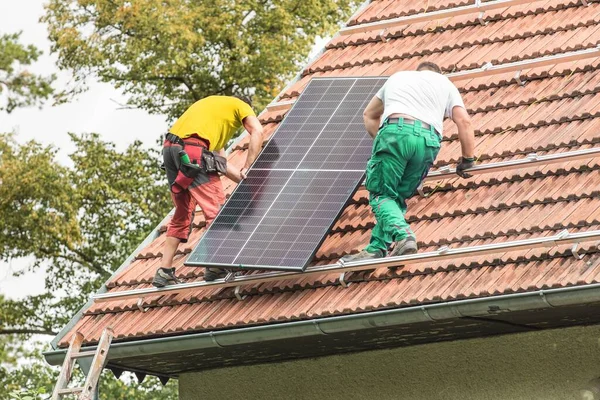 Man Installing New Solar Panels Roof Private House Renewable Energy stockfoto