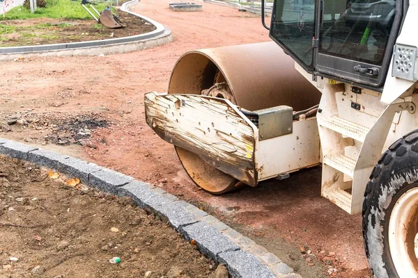 Vibration roller compactor at road construction and repairing asphalt pavement works. Road repair. Construction work.