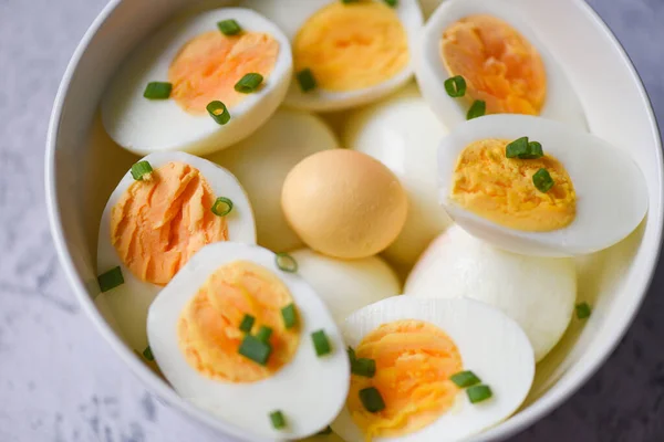 Eggs breakfast, fresh eggs menu food boiled eggs in a bowl decorated with leaves chopped fresh green onions, cut in half egg yolks for cooking healthy eating