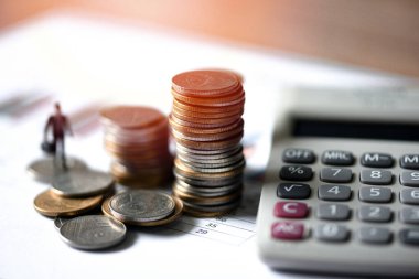 Yatırım konseptinin hesap makinesi analizi ile birlikte mali ve iş adamı paralarını iş grafiği kağıdına istifle.