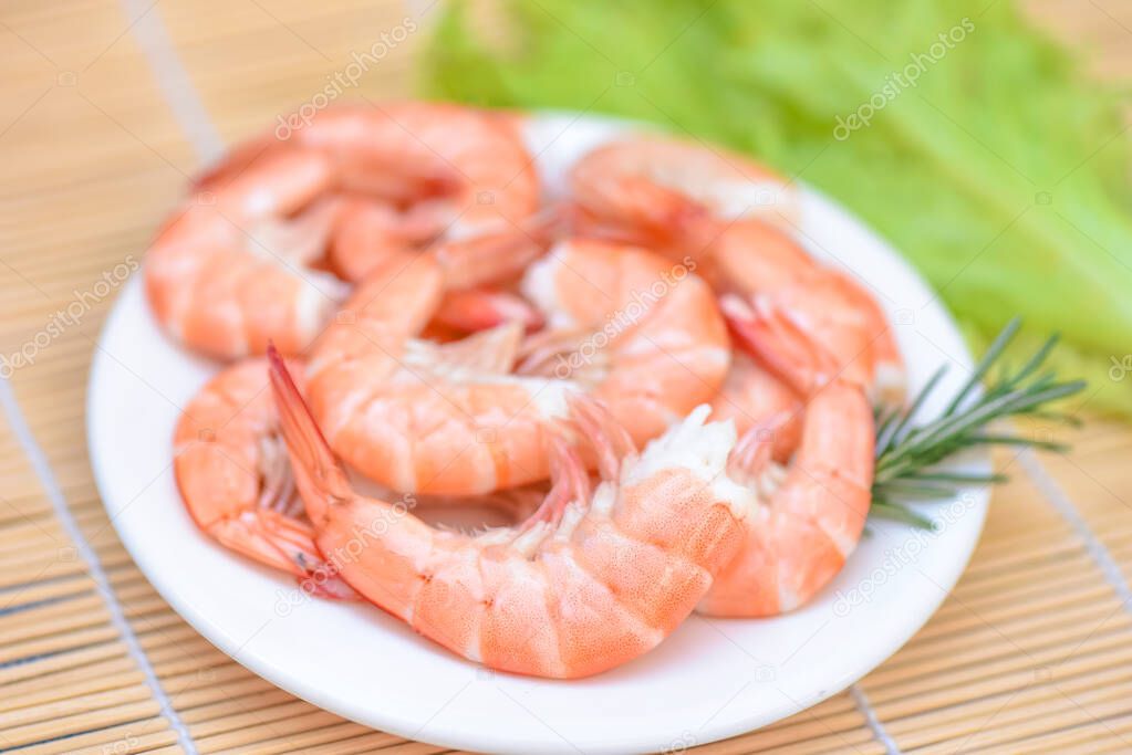 Fresh shrimps served on white plate, boiled peeled shrimp prawns cooked in the seafood restaurant