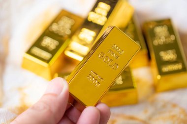 Gold bars in hand, Stack of gold bars financial business economy concepts, wealth and reserve success in business and finance