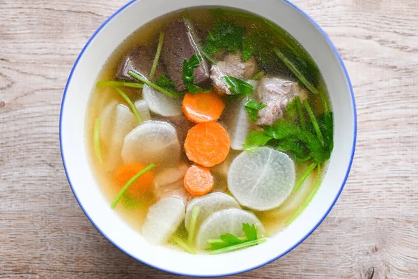 Menu healthy food , clear soup bowl with pork ribs pig pork blood vegetable and celery , Daikon radishes and carrot soup