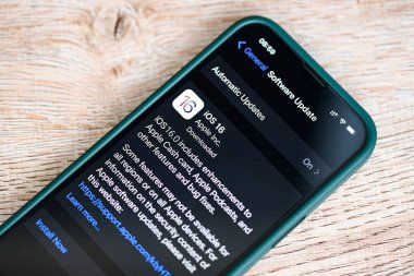 iPhone with iOS 16 logo on the screen close up, new operating system 2022-2023 on iPhone apple devices sub version ios 16 for download updates : Bangkok, Thailand - Augus 16 2022