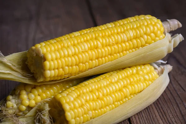 ripe corn cobs steamed or boiled sweetcorn for food vegan dinner or snack, cooked sweet corn on wooden background