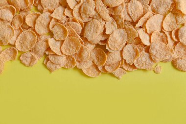 Cornflakes on yellow background, cornflakes breakfast food and snack for healthy food concept, morning breakfast fresh whole grain cereal
