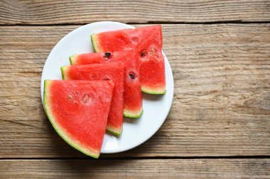 Watermelon slice on white plate background, Closeup sweet watermelon slices pieces fresh watermelon tropical summer fruit - top view 