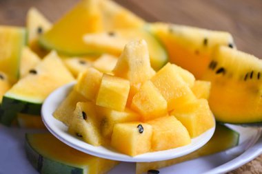 Yellow watermelon slice on white plate background, Closeup sweet watermelon slices pieces fresh watermelon tropical summer fruit