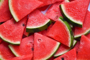 Watermelon slice on background, Closeup pile of sweet watermelon slices pieces fresh watermelon tropical summer fruit - top view 