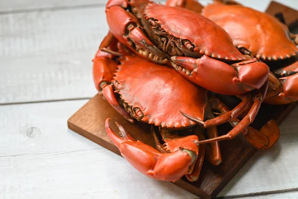 fresh crab on wooden cutting board, seafood crab cooking food boiled or steamed crab red in the seafood restaurant kitchen