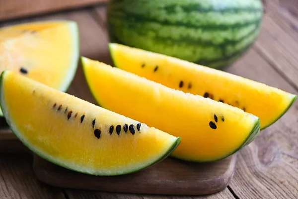 Yellow watermelon slice on wooden background, Closeup sweet watermelon slices pieces fresh watermelon tropical summer fruit