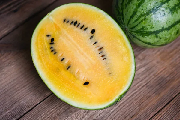 Yellow watermelon cut half on wooden, Closeup pile of sweet watermelon slices pieces fresh watermelon tropical summer fruit