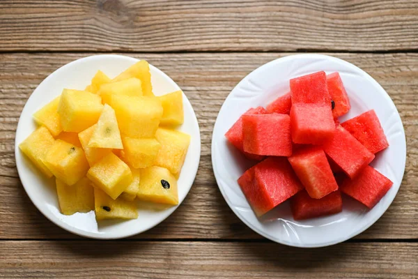 Red and yellow watermelon slice on white plate, sweet watermelon slices pieces fresh watermelon tropical summer fruit - top view