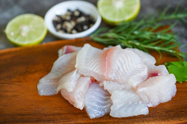 fresh raw pangasius fish fillet with, meat dolly fish tilapia striped catfish, fish fillet on wooden board with ingredients celery for cooking