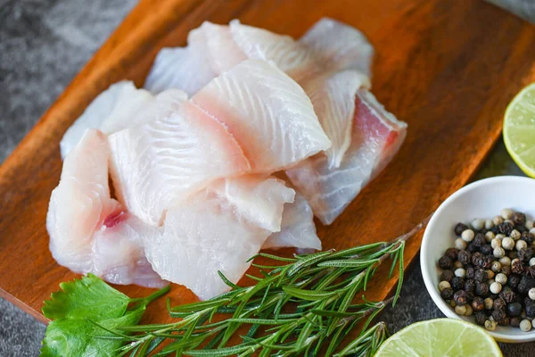 fresh raw pangasius fish fillet with, meat dolly fish tilapia striped catfish, fish fillet on wooden board with ingredients celery for cooking