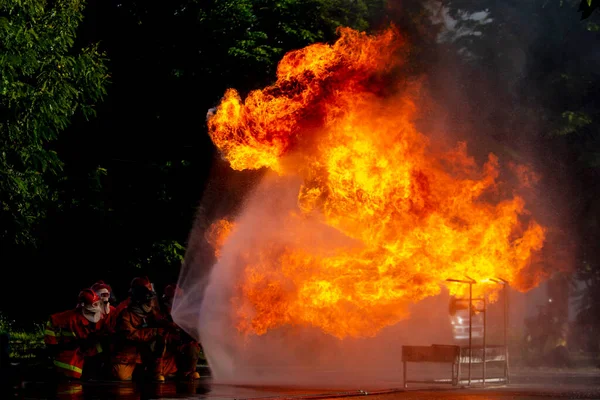 Firefighters Practicing Firefighting Plans Putting Out Burning Fire Stock Photo