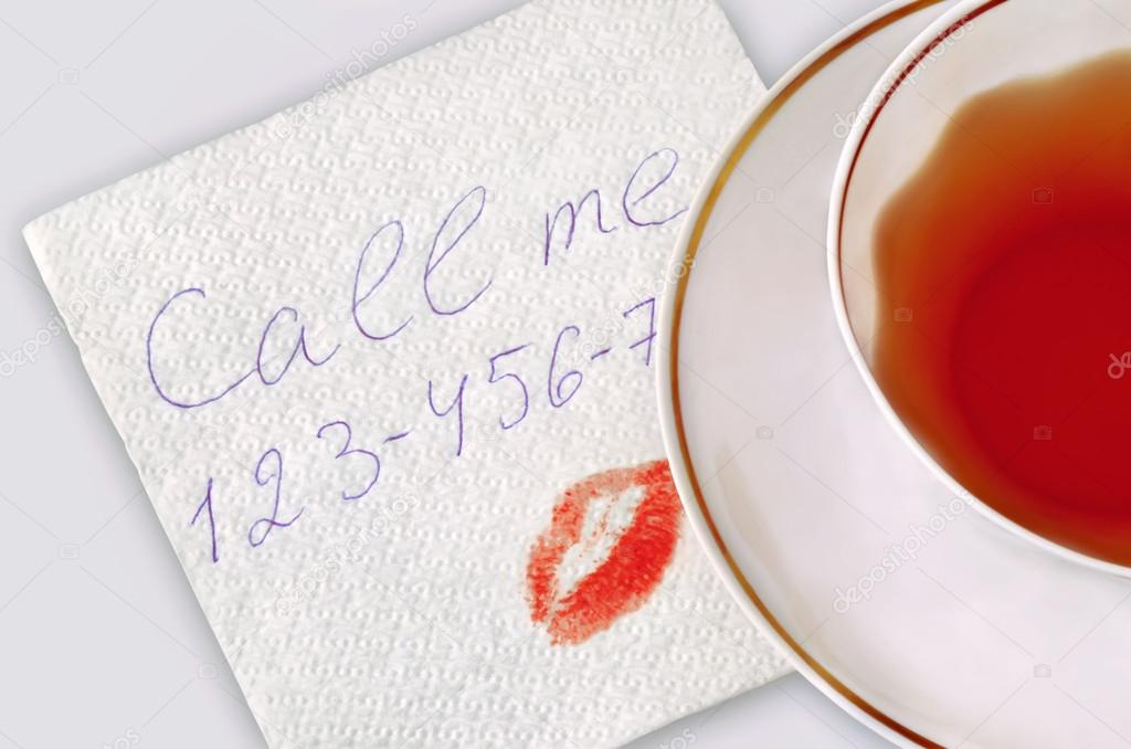 Napkin with phone number and kiss.