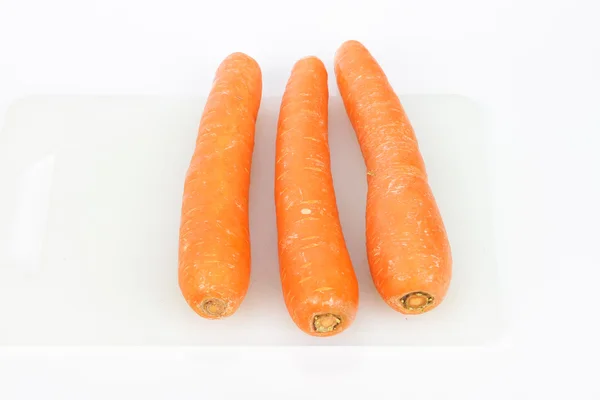 Fresh carrot on cutting board — Stock Photo, Image