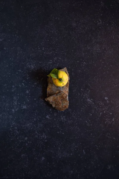 Bodegón amarillo y verde limones en un fondo de piedra negro — Foto de Stock