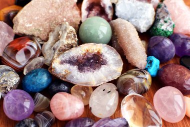 Güzel değerli taşlar, jeot ametist ve ahşap arka planda bulunan doğal mor mineral ametistleri. Ametist ve gül kuvars. Yarı değerli taşların büyük kristalleri..