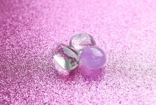 Gemstone minerals on a pink background. Round tumbling minerals of amethyst, rose quartz, apatite, turquoise, agate