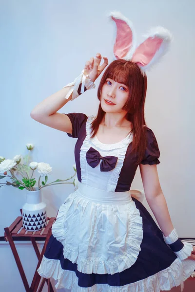 A beautiful maid in a maid\'s costume