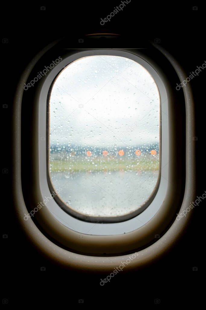 Raindrops outside the plane window