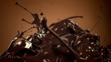 Kahverengi Gradyan Arkaplanda 1000 fps 'de Süper Yavaş Su Sıçratma Çekimi Eritilmiş Çikolata. 4K Çözünürlükte Yüksek Hız Sinema Kamerası ile Çekim.