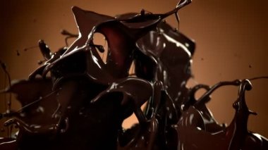 Kahverengi Gradyan Arkaplanda 1000 fps 'de Süper Yavaş Su Sıçratma Çekimi Eritilmiş Çikolata. 4K Çözünürlükte Yüksek Hız Sinema Kamerası ile Çekim.