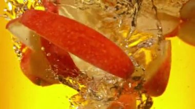 Kırmızı Elma Dilimlerinin Süper Yavaş Çekimi Juice Girdabına 1000 fps hızla düşüyor. 4K 'da yüksek hızlı sinema kamerasıyla çekildi..