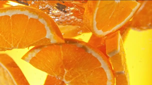 Super Slow Motion Shot Fresh Orange Shices Rotating Water Vortex — Stock video