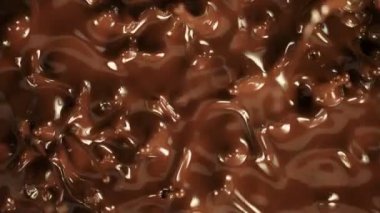 Süper Yavaş Hareket Detaylı Sıçrayan Erimiş Çikolata Çekimi 1000 fps 'de. Yüksek Hız Sinema Kamerası ile 4K çözünürlükte çekilmiştir.