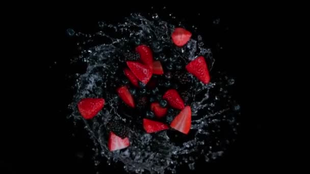 超级慢镜头旋转爆炸浆果水果与溅水在黑色在1000Fps 用高速电影摄影机拍摄 — 图库视频影像