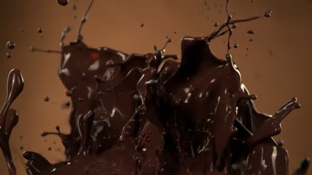 Super Slow Motion Shot Splashing Melted Chocolate Brown Gradient Background — Vídeo de Stock