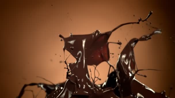 Super Slow Motion Shot Splashing Melted Chocolate Brown Gradient Background — Vídeo de Stock