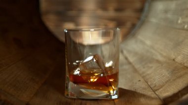 Süper Yavaş Çekim Buz Küpü Tahta Fıçı 'nın içinde 300 metrede viski bardağına düşüyor. 4K 'da Yüksek Hız Sinema Kamerası ile çekildi..