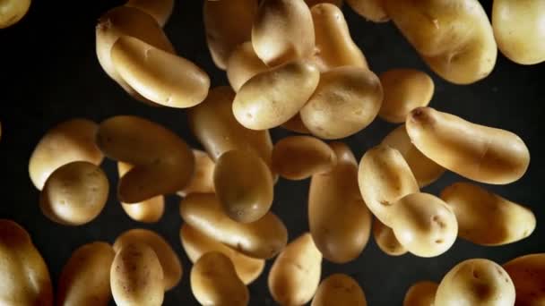 Super Slow Motion Shot Fresh Potatoes Flying Camera Black Background — Vídeo de Stock