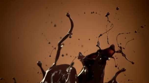 Super Slow Motion Shot Splashing Melted Chocolate Brown Gradient Background — Αρχείο Βίντεο