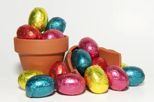 Colored Easter eggs and terracotta flower pot — Stock Photo, Image