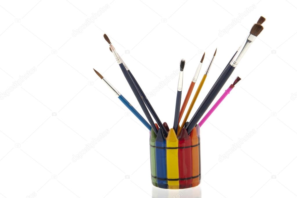 Collage of paintbrushes in a colourfull cup