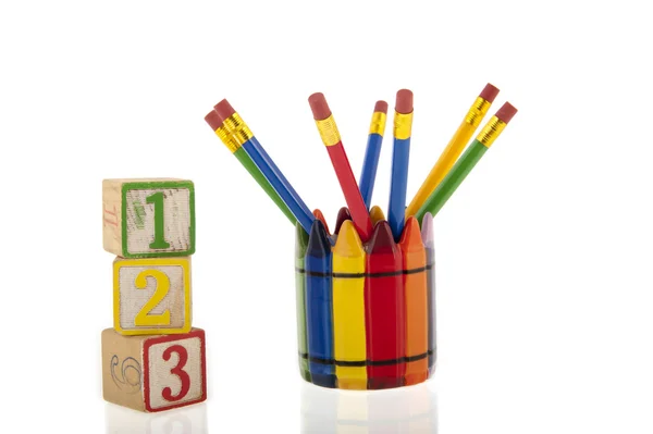 Collage of colourfull pencils in a cup next to three 1-2-3 cubes — Stock Photo, Image