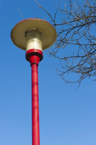 Ancient lamppost at parking of gasstation on highway — Stock Photo, Image