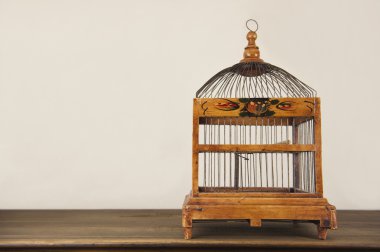 bird cage on wooden shelf clipart