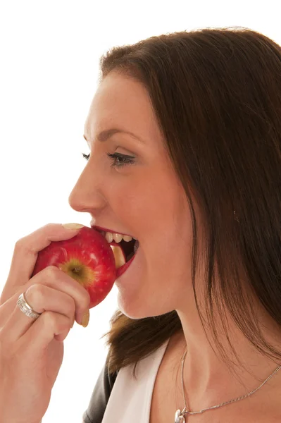 Girl bites an apple with a smile — Stock Photo, Image