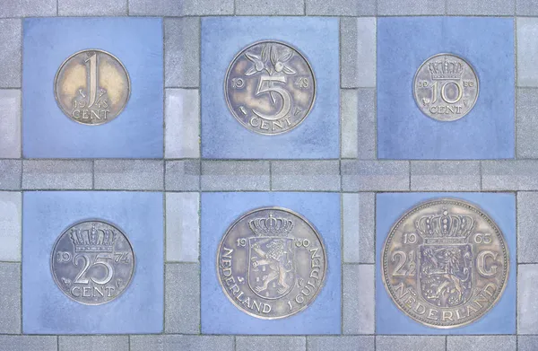 Collection of former Dutch coins in pavement — Stock Photo, Image