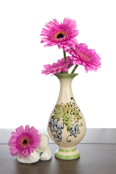 Pink Gerbera in decorated vase and white stones — Stock Photo, Image