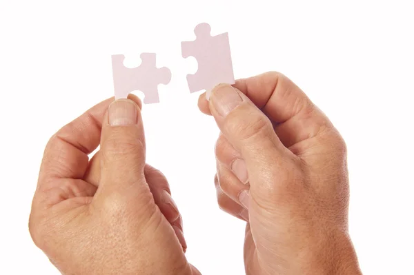 Hands connect jigsaw puzzle pieces — Stock Photo, Image