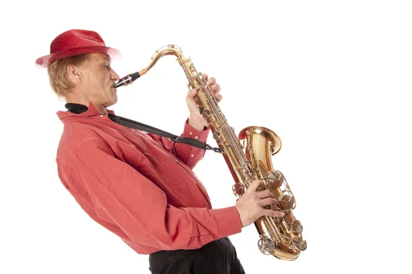 Muž hraje tenor saxofon naklonil se dozadu — Stock fotografie
