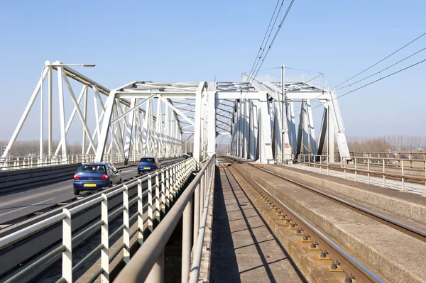 Combined railway and car bridge over river — Stock Photo, Image