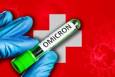 Switzerland outbreak of omicron variant. A hand in a blue rubber glove holds a test tube with covid-19 virus omicron in front of Switzerland flag. Omicron variant outbreak concept